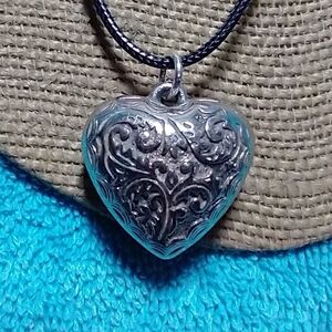 Silvertone intricate design puffy heart black cord necklace